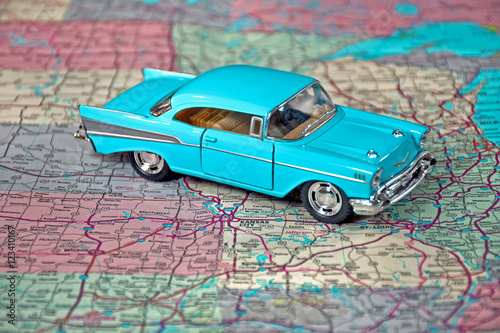 retro turquoise car on road map