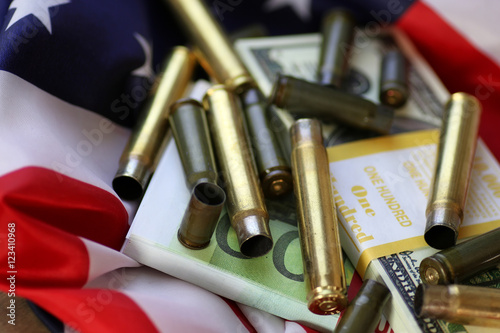 bullet and money on the american flag