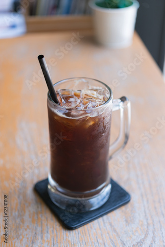 Obraz na płótnie Iced Americano black coffee on a wooden table. shallow depth of w salonie