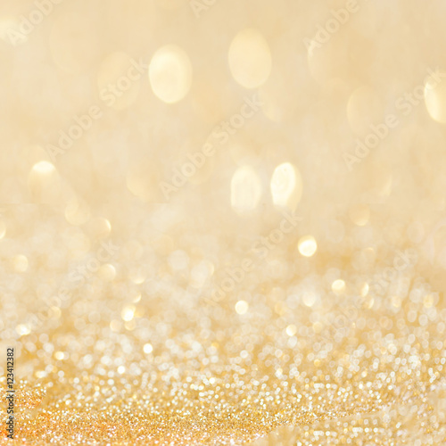 Golden glitter christmas abstract background with bokeh defocuse
