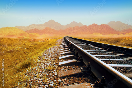 Railway in the Valley. Railway in the desert. railroad through the mountains. Transportation theme. Wild path for train