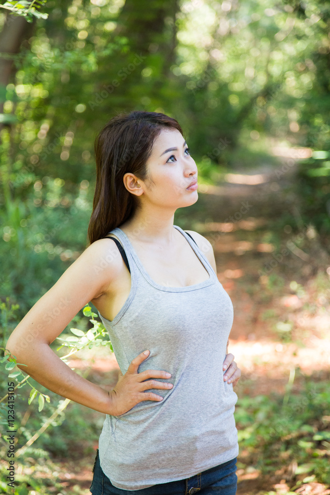 Beautiful young woman is in the green forest Beautiful young woman is in the green forest