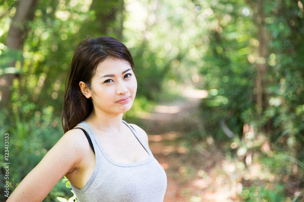 Beautiful young woman  is in the green forest