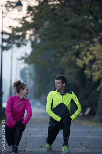 couple warming up before jogging