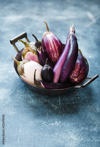 Colorful purple eggplants over linen napkin. Copy space.