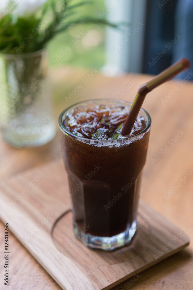 Iced Americano black coffee on a wooden table. shallow depth of