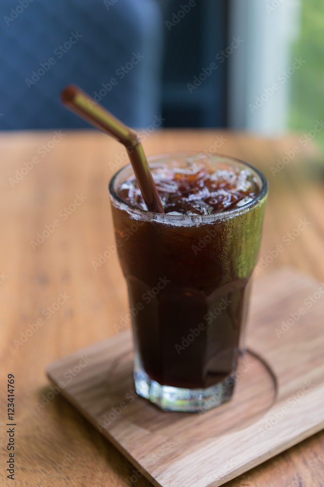 Iced Americano black coffee on a wooden table. shallow depth of