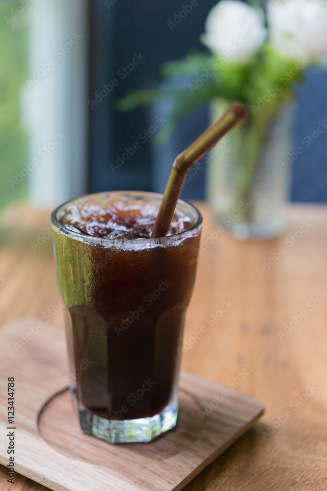 Iced Americano black coffee on a wooden table. shallow depth of