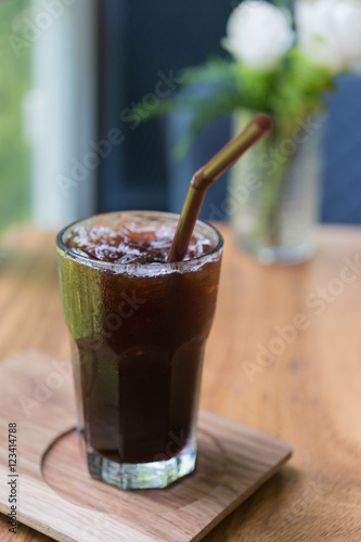 Obraz na płótnie Iced Americano black coffee on a wooden table. shallow depth of w salonie