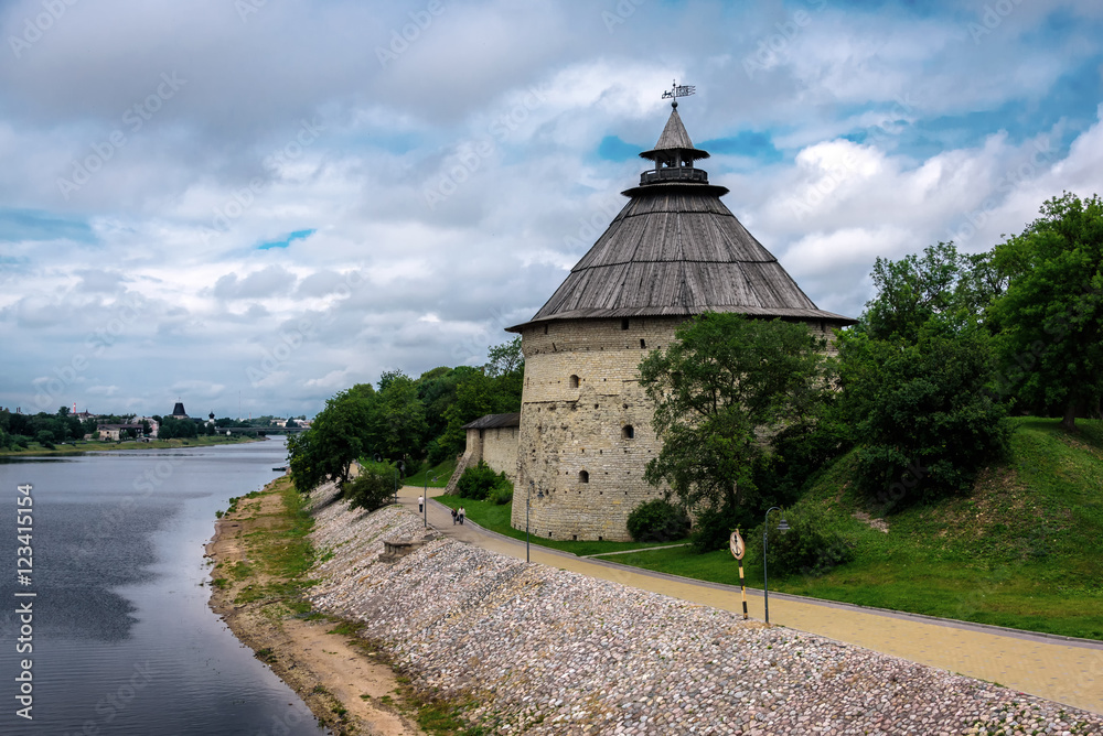 Watchtower of the Pskov Kremlin at the river in summer day