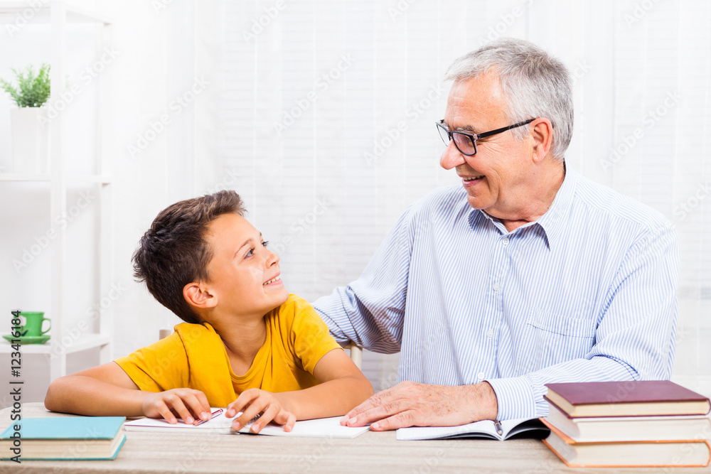 Grandfather is teaching his grandson at home. Grandfather is teaching his grandson at home.