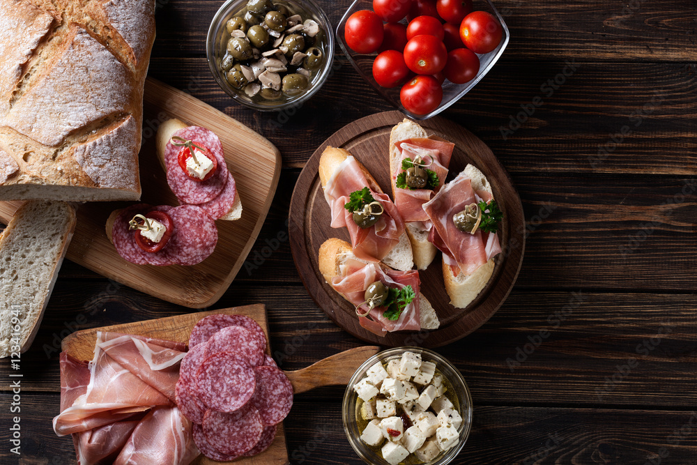 Spanish tapas with slices jamon serrano, salami, olives and chee