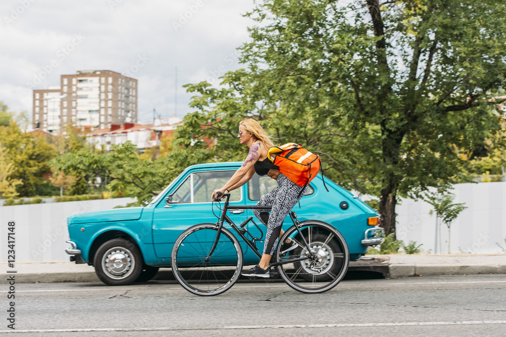 Woman riding bike down the street. Woman riding bike down the street.