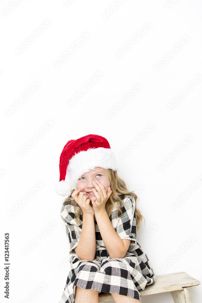 Happy christmas girl in Santa hat on white background Happy christmas girl in Santa hat on white background