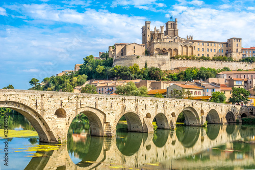Panoramic view at the Old Bridge over Orb river with Cathedral of Saint Nazaire in Beziers - France photo
