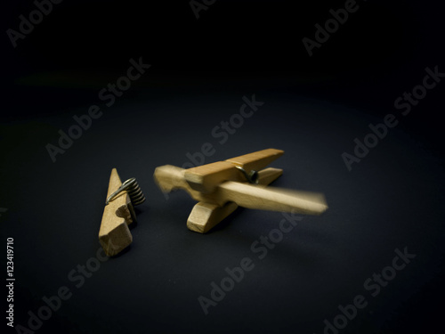 Aggressive clothespins. Fighting of wooden clothespins on dark background. Illustration aggression issues. Part of photoset.