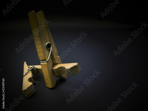 Aggressive clothespins. Fighting of wooden clothespins on dark background. Illustration aggression issues. Part of photoset.
