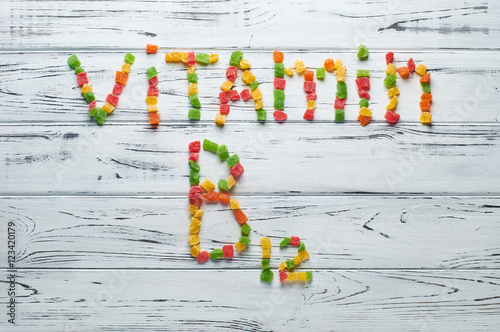 From pieces of colored candied fruits laid out the word vitamin B12.