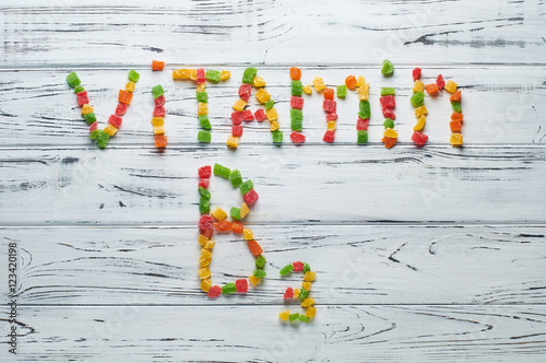 From pieces of colored candied fruits laid out the word vitamin B3.