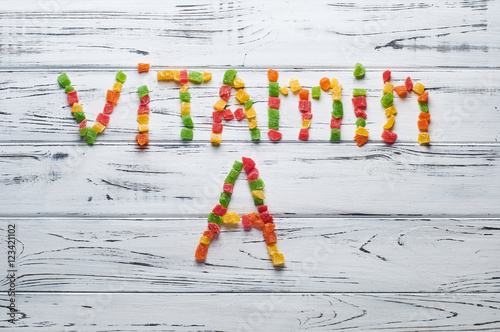 From pieces of colored candied fruits laid out the word vitamin A.
