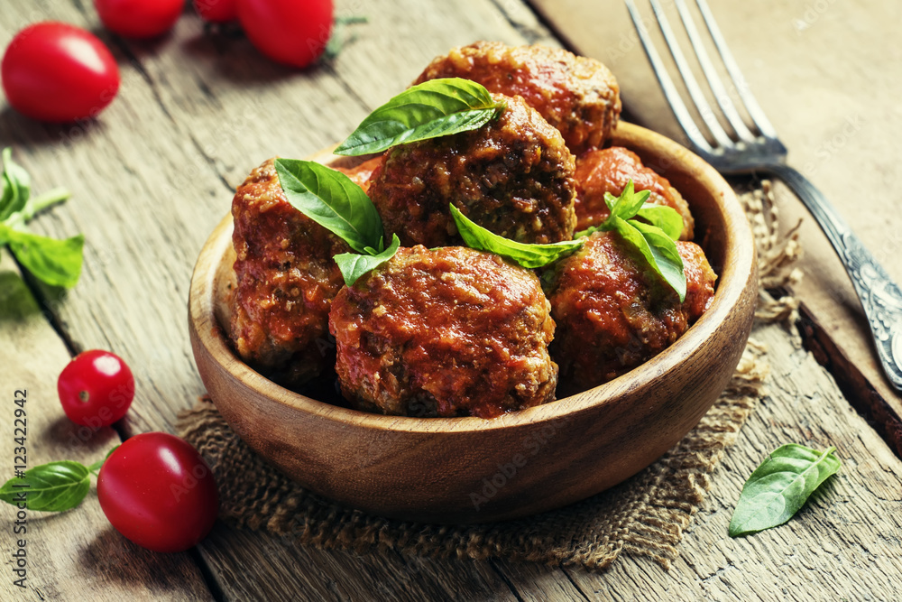 Meatballs of pork and beef with spicy tomato sauce in bowl, vint