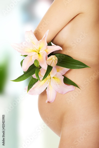 Pregnant woman holding a lily flower