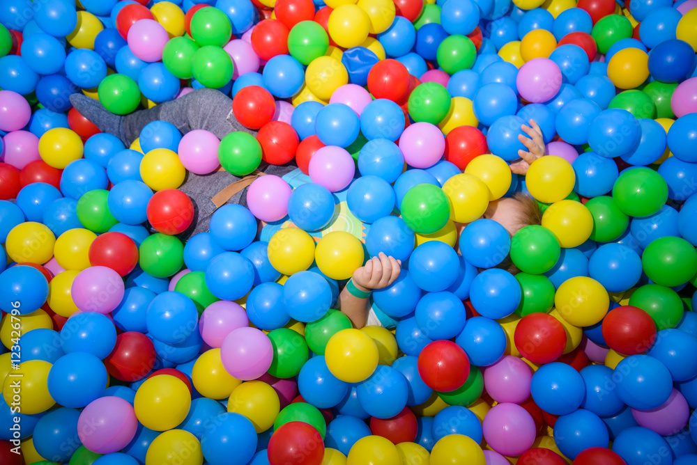 kid playing in pool of balls kid playing in pool of balls