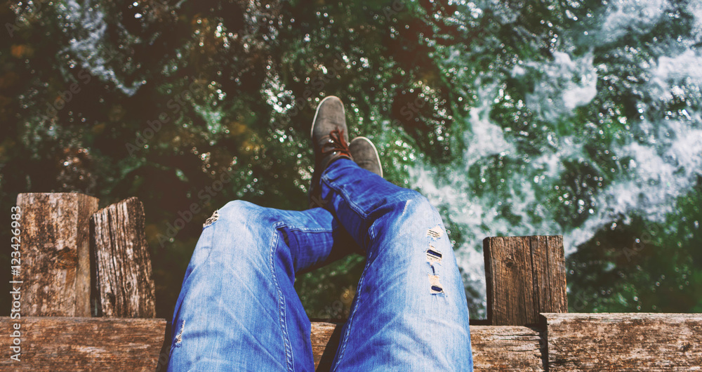 Mann mit Jeans sitzt am Abgrund (Oberkörper) Stock Photo | Adobe Stock