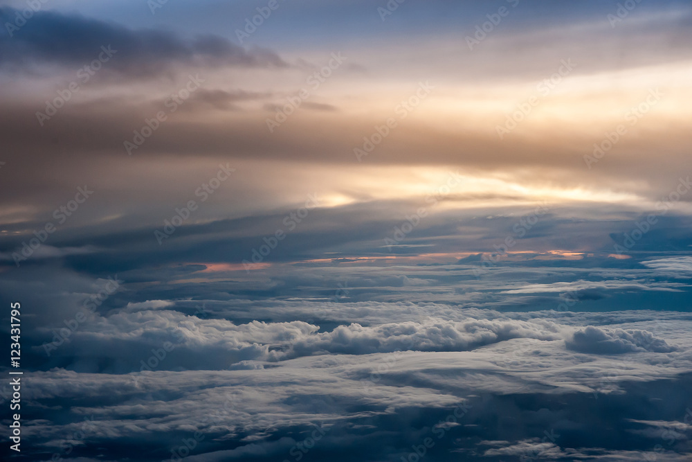 Aerial view of a cloudy sunset while flying above the clouds Aerial view of a cloudy sunset while flying above the clouds