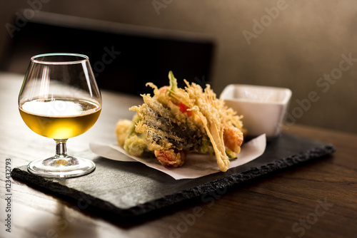 Vegetable tempura shrimps with a glass of beer.
