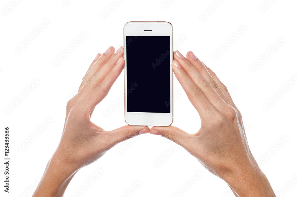 Woman hands holding latest mobile handset Woman hands holding latest mobile handset