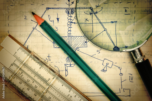 Obraz na plátně magnifying glass and a slide rule on the old page with the calcu