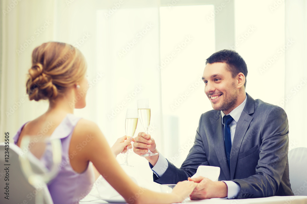 couple with glasses of champagne at restaurant couple with glasses of champagne at restaurant