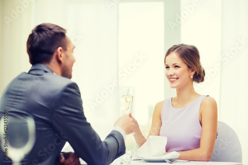 couple with glasses of champagne at restaurant