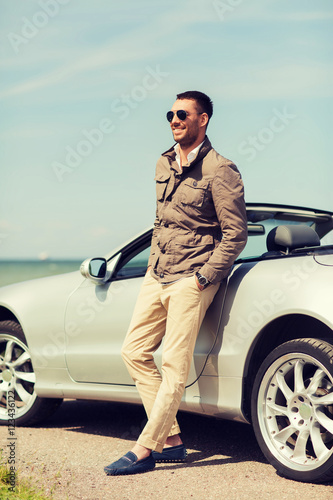 happy man near cabriolet car outdoors © Syda Productions