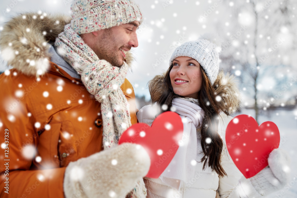happy couple with red hearts over winter landscape happy couple with red hearts over winter landscape