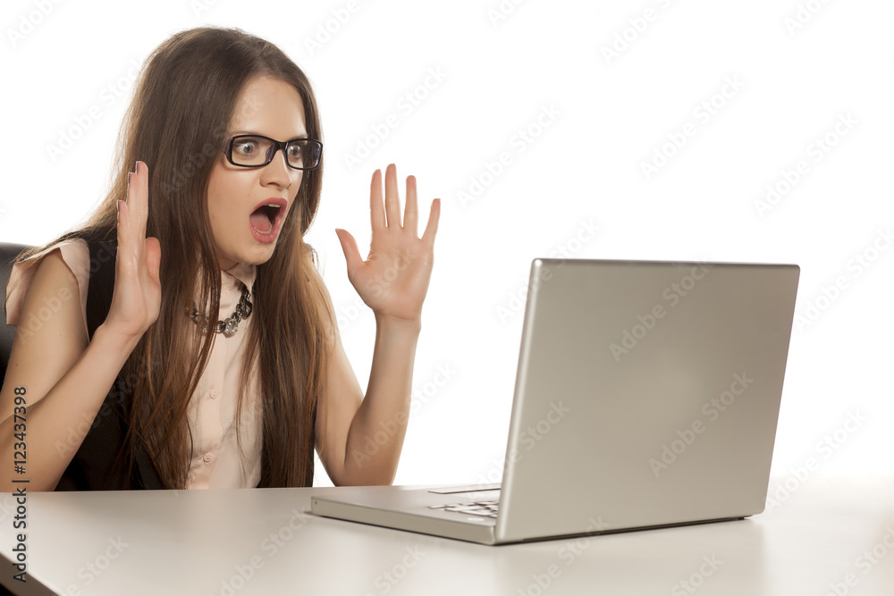 shocked business woman looking at her laptop shocked business woman looking at her laptop