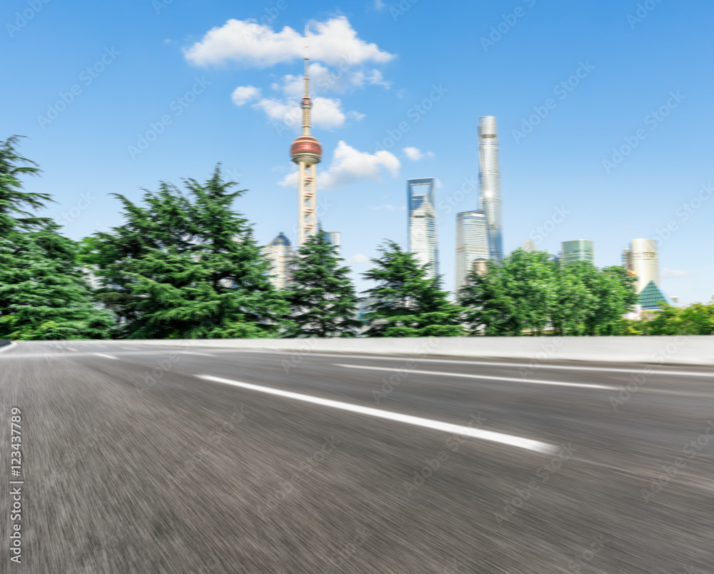 Motion blur asphalt road and Shanghai cityscape in China