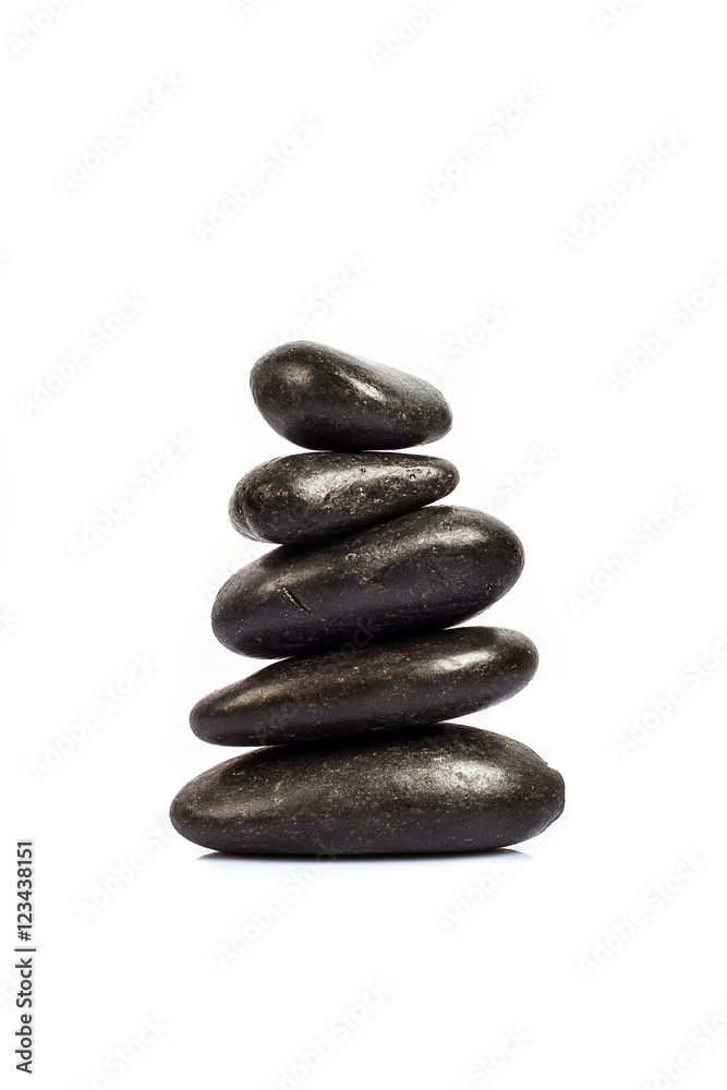 stack of five black stones on a white background stack of five black stones on a white background
