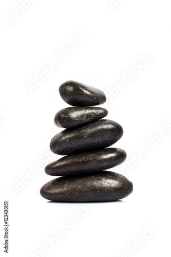 stack of five black stones on a white background