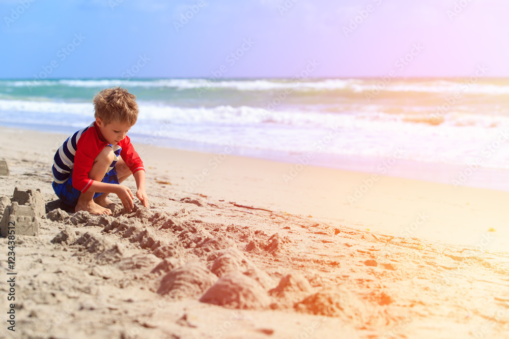 little boy play with sand on summer beach little boy play with sand on summer beach