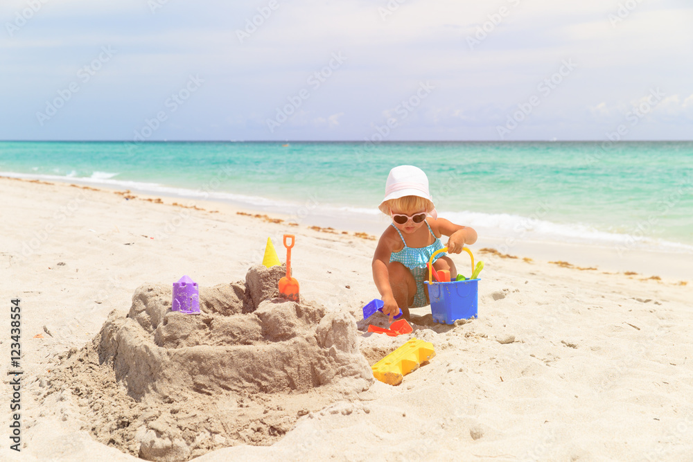 cute little girl play with sand on beach cute little girl play with sand on beach