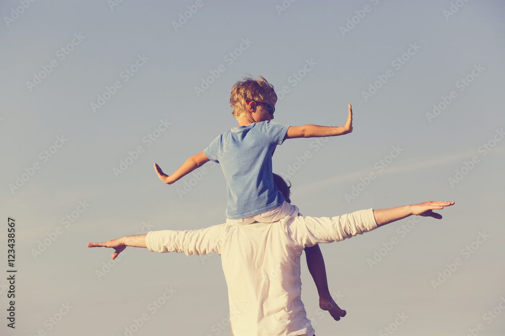 happy father and son playing on sky happy father and son playing on sky