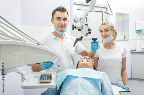 Dentist, assistant and patient in clinic