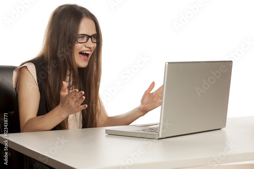 exited happy business woman looking at her laptop