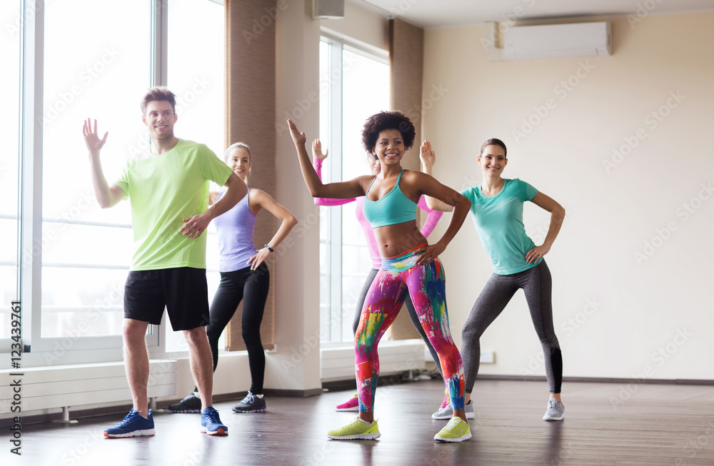 group of smiling people dancing in gym or studio group of smiling people dancing in gym or studio