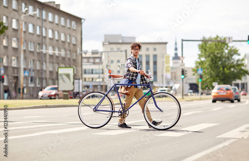 young man with fixed gear bicycle on crosswalk © Syda Productions
