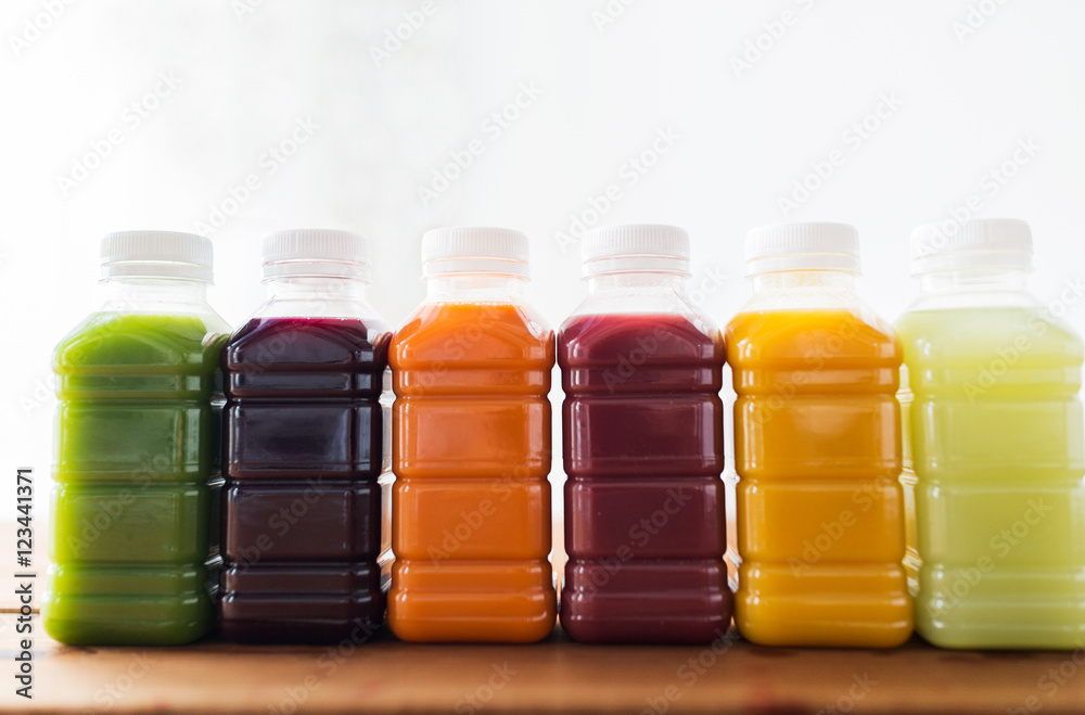 bottles with different fruit or vegetable juices bottles with different fruit or vegetable juices