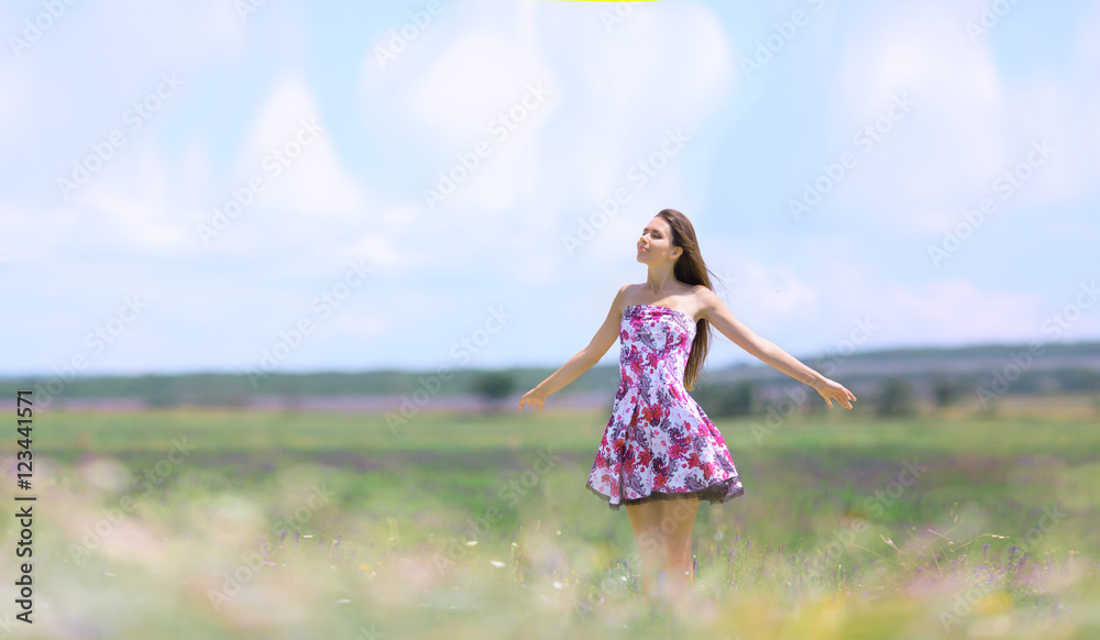 Pretty girl posing on lavender field, looking fresh and happy Pretty girl posing on lavender field, looking fresh and happy