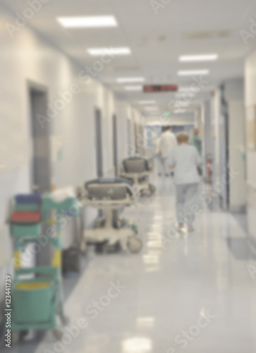 Doctors and nurses walking in hospital hallway  blurred motion.